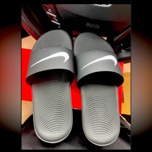 Kids black Nike slides